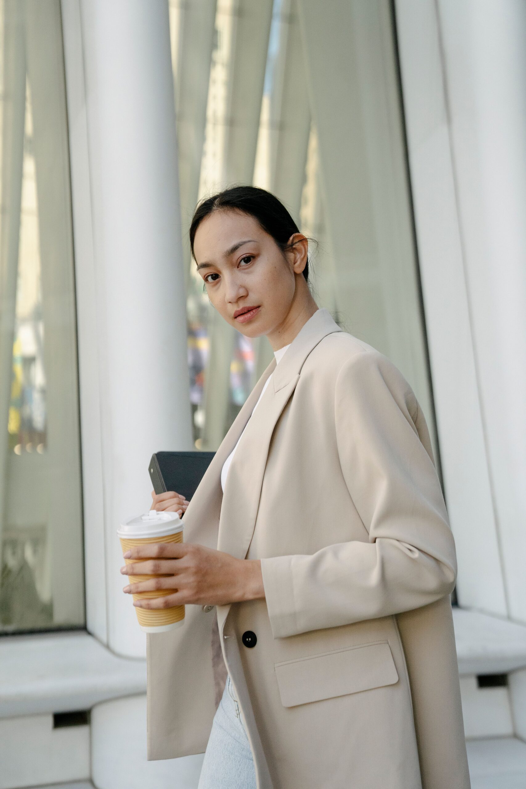 Young woman in tailored beige blazer styling this season's new arrivals
